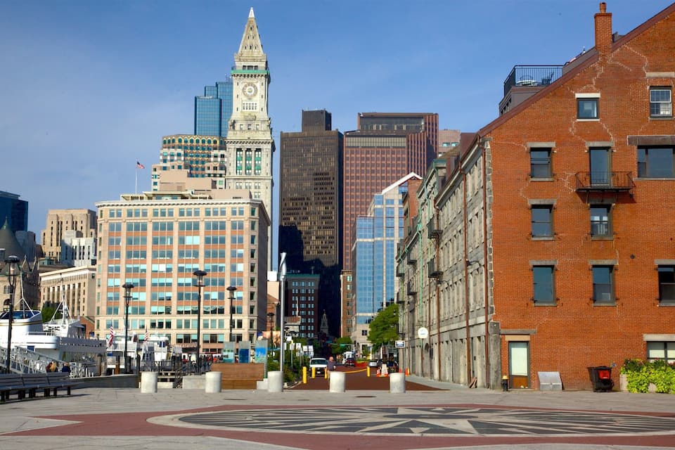 A cityscape with a prominent clock tower, modern skyscrapers, and a mix of historic and contemporary architecture.