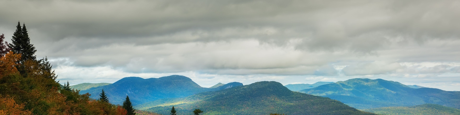 Mountains overgrown with deciduous forests and colorful variegated autumn trees.White Mountain National Park. USA. New Hamshire.