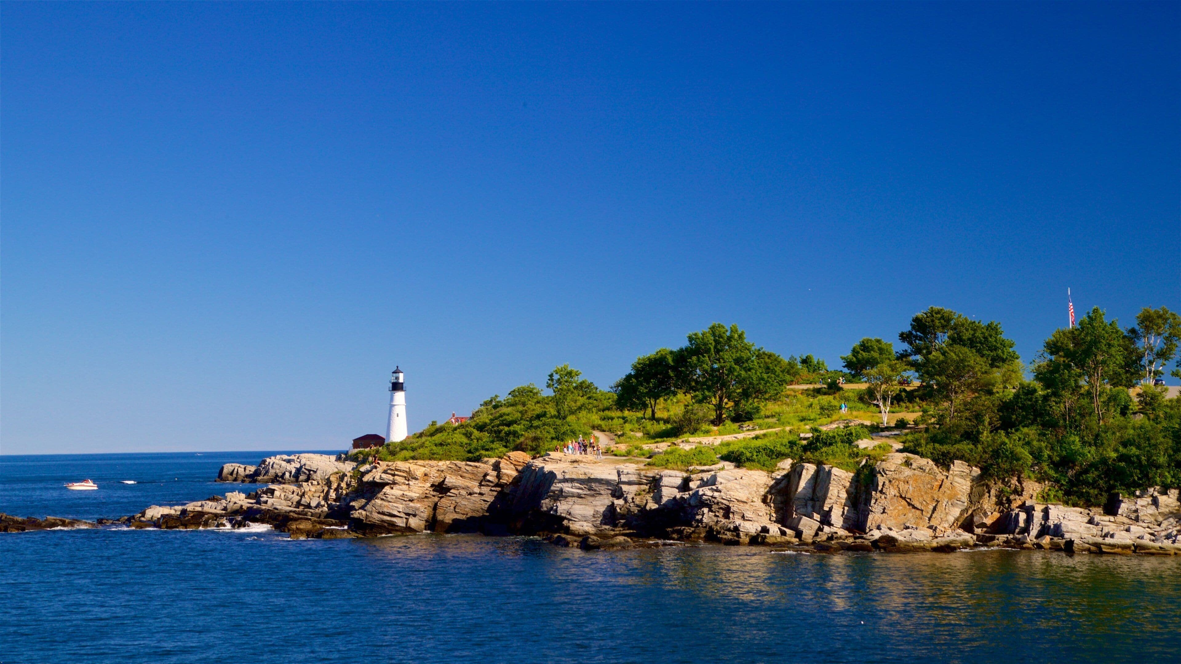 Fort Williams Park featuring a lighthouse, rugged coastline and general coastal views