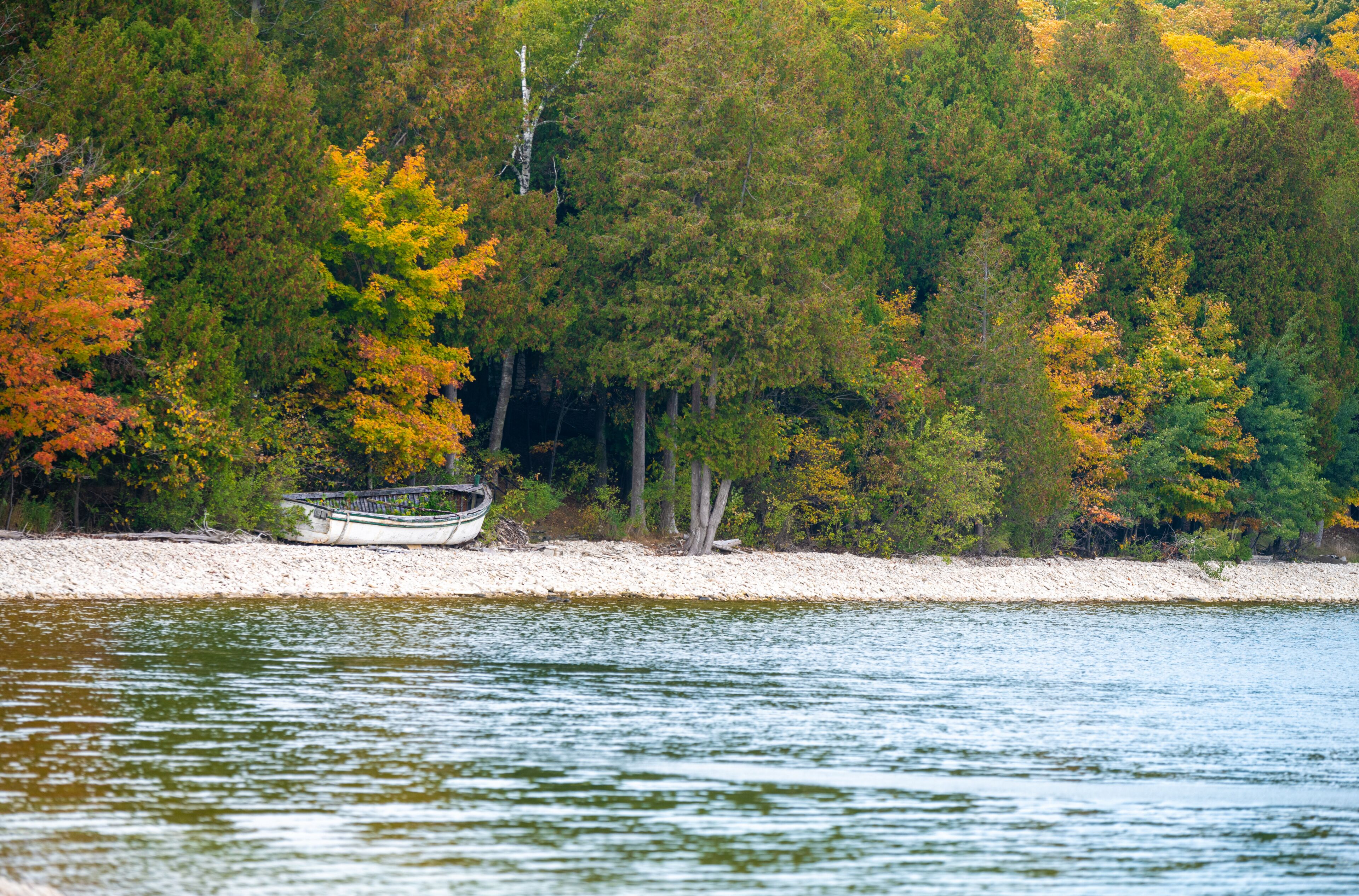 School House Beach on Washington Island Door County Wisconsin autumn colors boat in the distance sunset