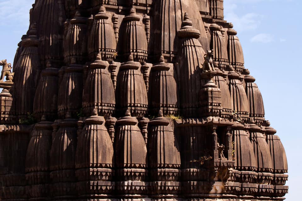 A large, intricately carved temple with multiple tiers and spires.