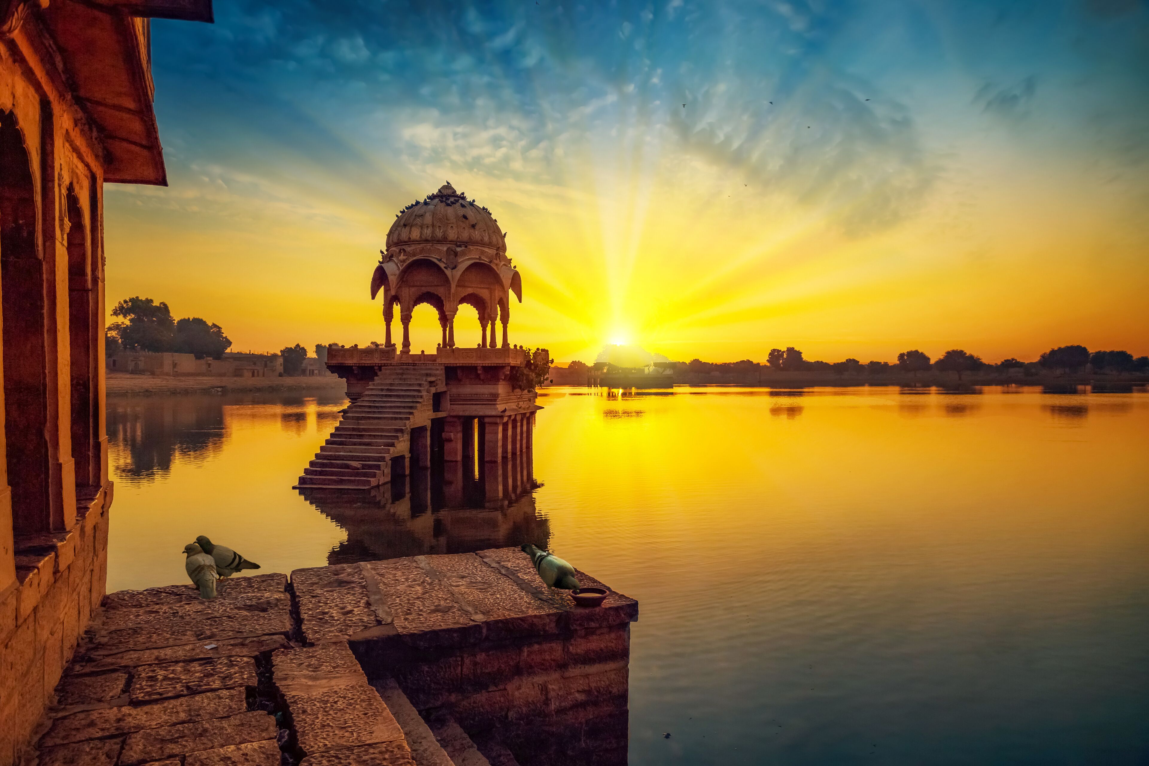 Sunrise at the Gadi Sagar (Gadisar) lake Jaisalmer Rajasthan India with ancient architecture.