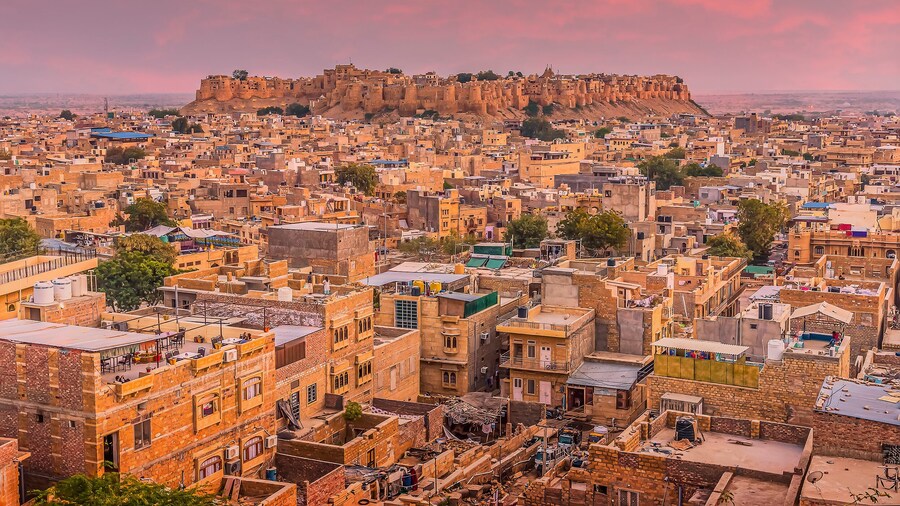 The golden city of Jaisalmer glows beneath the setting sun in Rajasthan, India