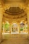 An ornate architectural structure with intricate carvings and a domed ceiling.
