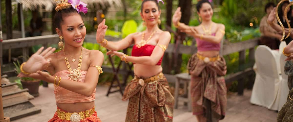 Thai women dancing in traditional dress at Siam Niramit, Bangkok, Thailand, Asia