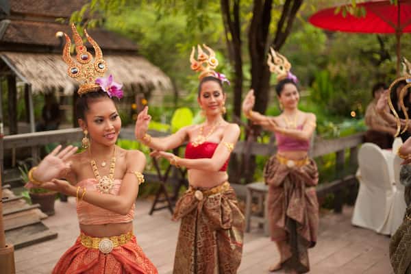 Thai women dancing in traditional dress at Siam Niramit, Bangkok, Thailand, Asia