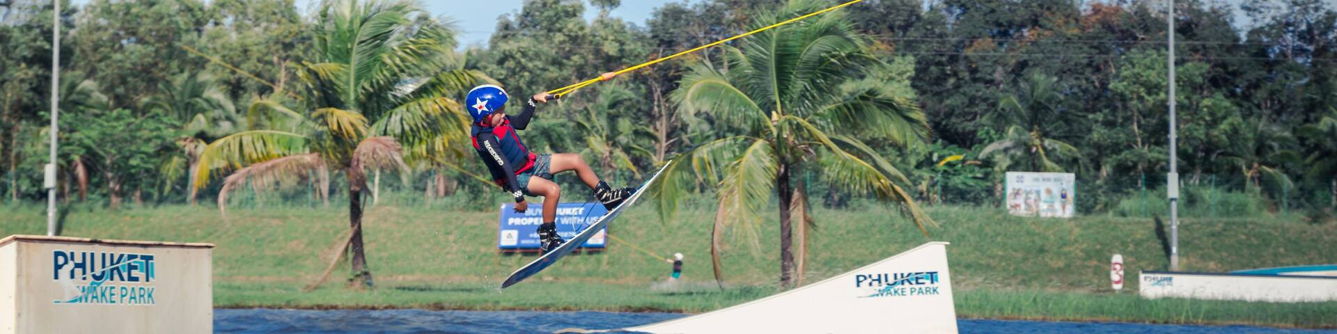 Phuket, Thailand - 10 January 2018 : Kid jumping while playing wake board at Phuket wake park