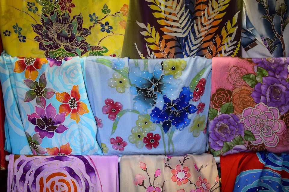 A display of colorful fabrics with floral patterns.