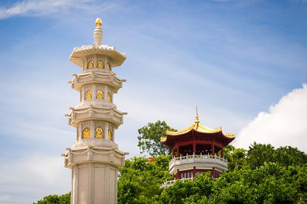 A pagoda with multiple tiers and a traditional red and gold pavilion.