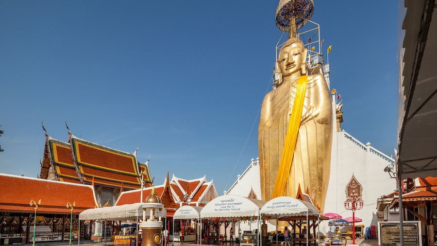 Giant standing golden Buddha at Beautiful Wat Intharawihan temple in Bangkok, Thailand