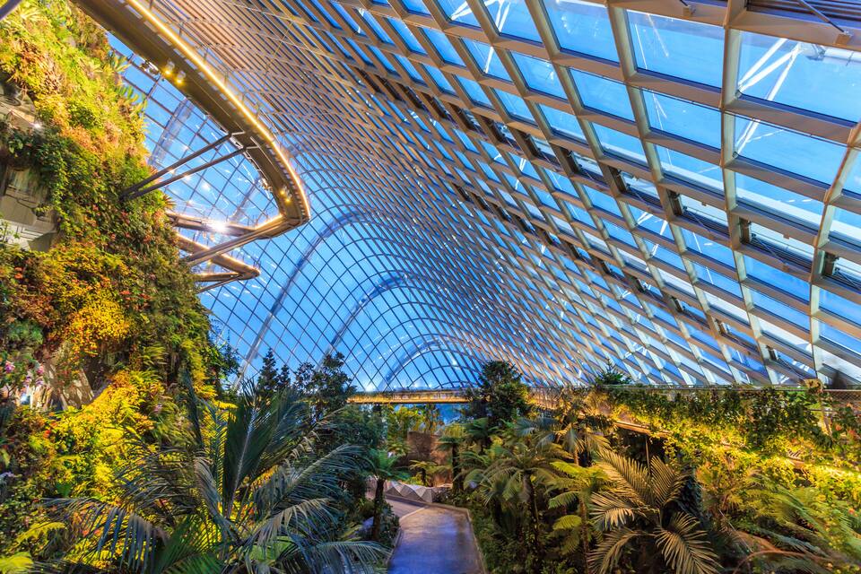 A glass-domed structure with a lush interior garden.