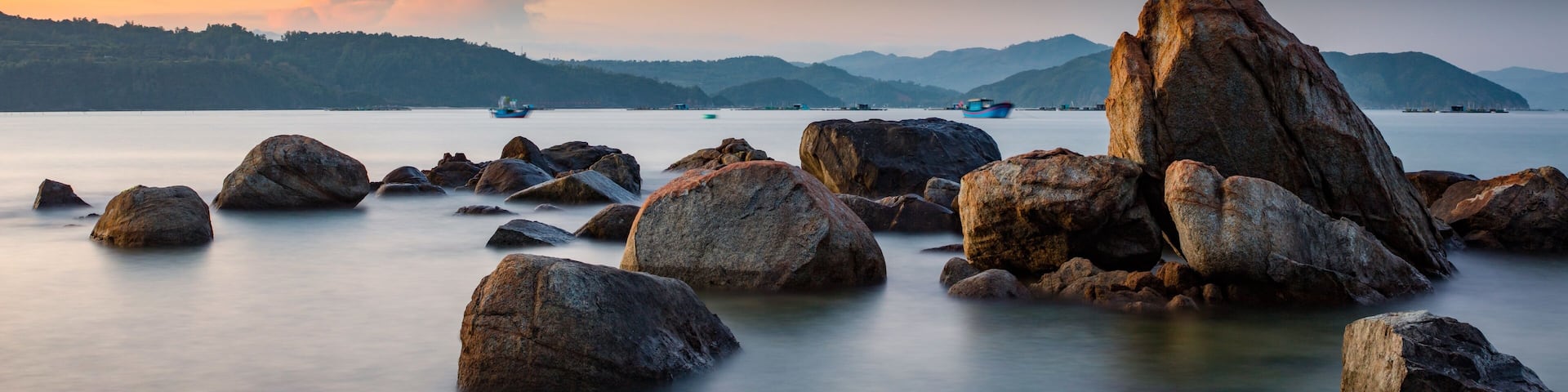 A rocky coastline at sunset looking out over the south China sea in Vung Lam Bay Vietnam.