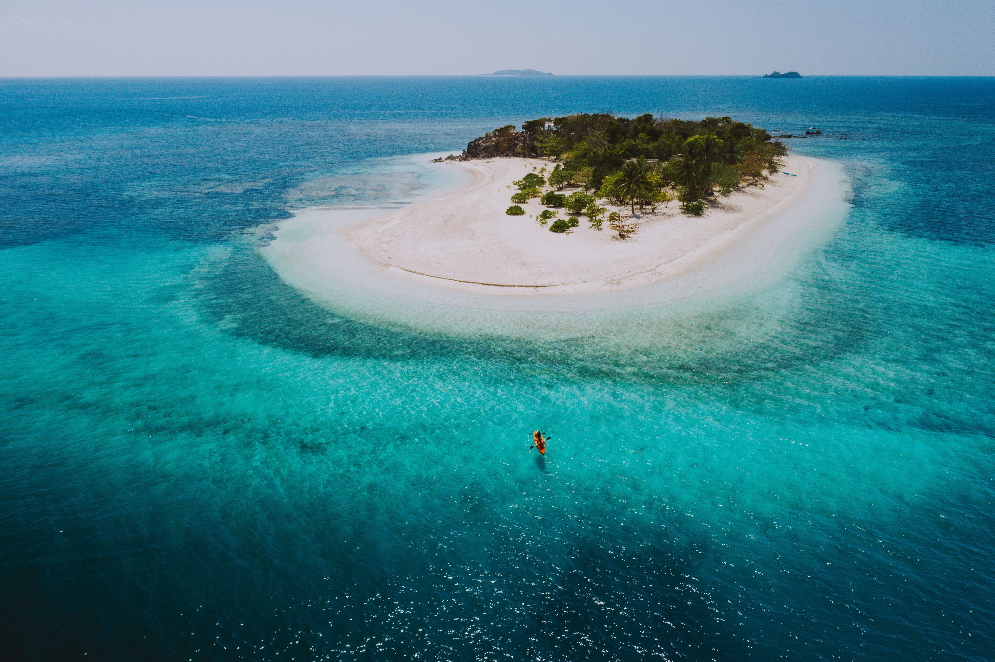Couple spending time on a beutiful remote tropical island in the philippines. Concept about vacation and lifestyle. kayaking and doing activities
