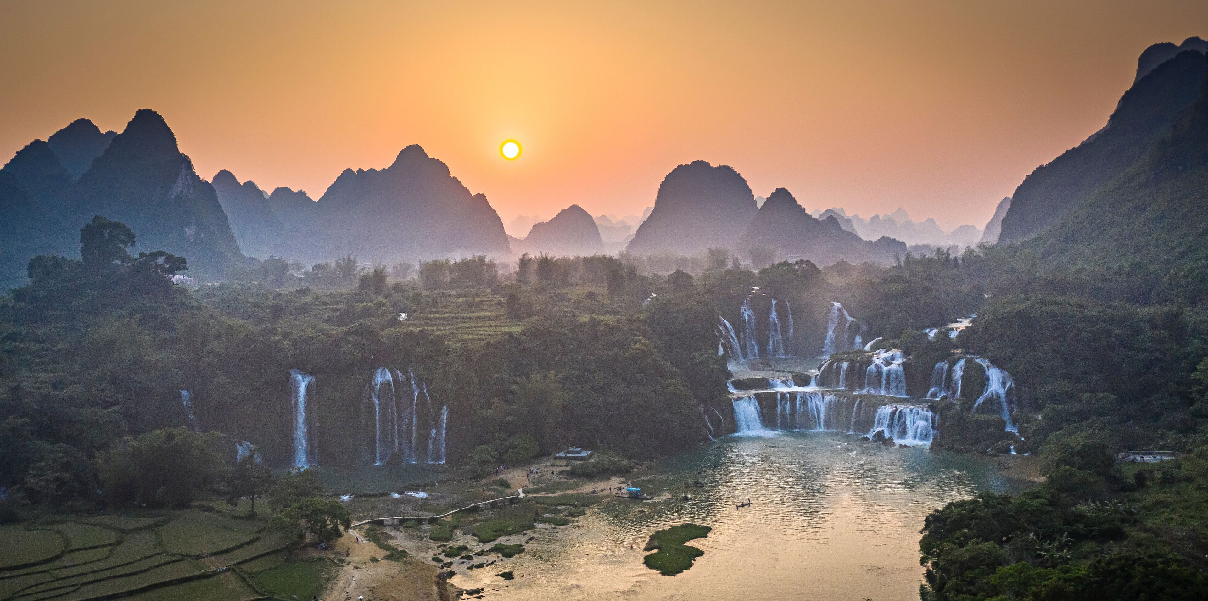 Aerial view of Detian Transnational Waterfalls along the river at Moon Hill Yangshuo valley, Chongzuo City, Yangshuo County, Guilin, Guangxi Zhuang Autonomous Region, China.