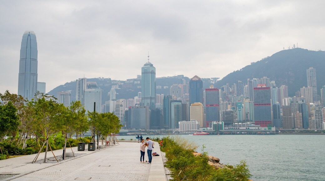 Kowloon West Promenade featuring a city and a bay or harbor as well as a couple
