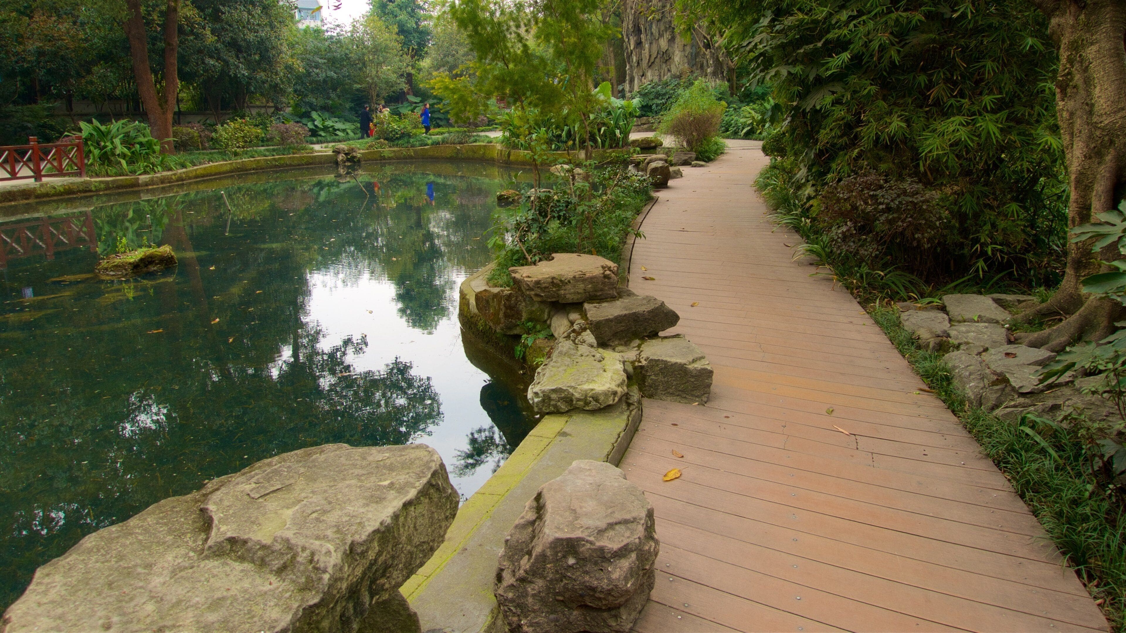 Baihuatan Park which includes a garden and a pond