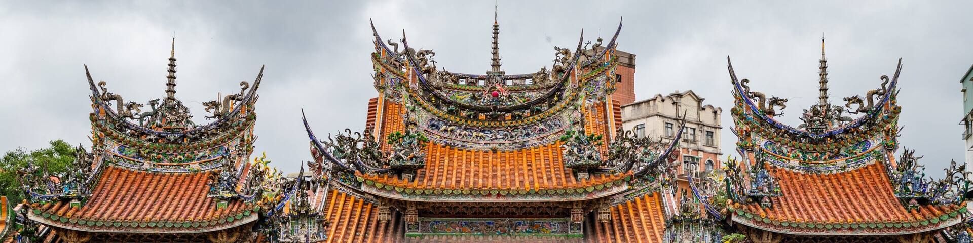 A traditional multi-tiered temple with ornate roofs and intricate carvings.