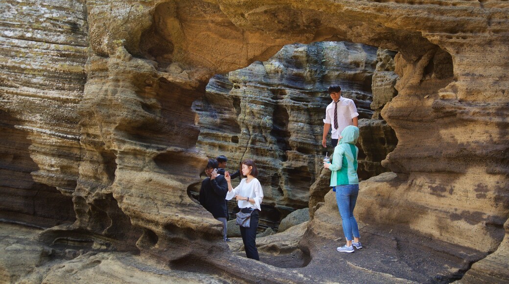 Yongmeori Coast featuring rugged coastline as well as a small group of people