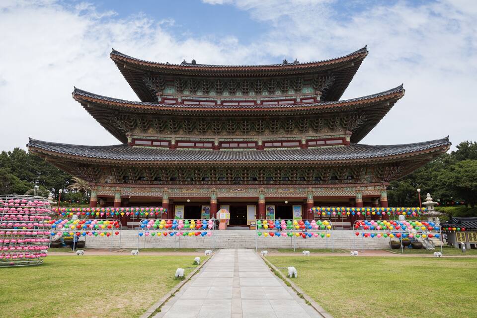 A traditional multi-tiered building with a tiled roof and a central entrance.