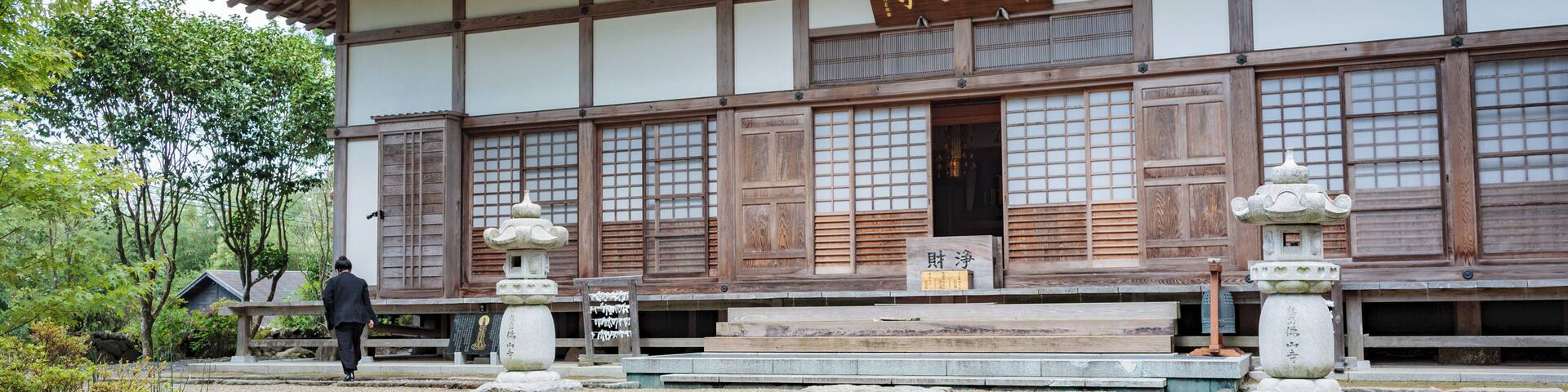 A traditional Japanese building with a tiled roof and wooden beams.