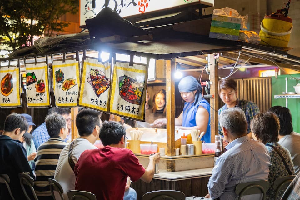 A street food stall with various food items displayed on the counter.