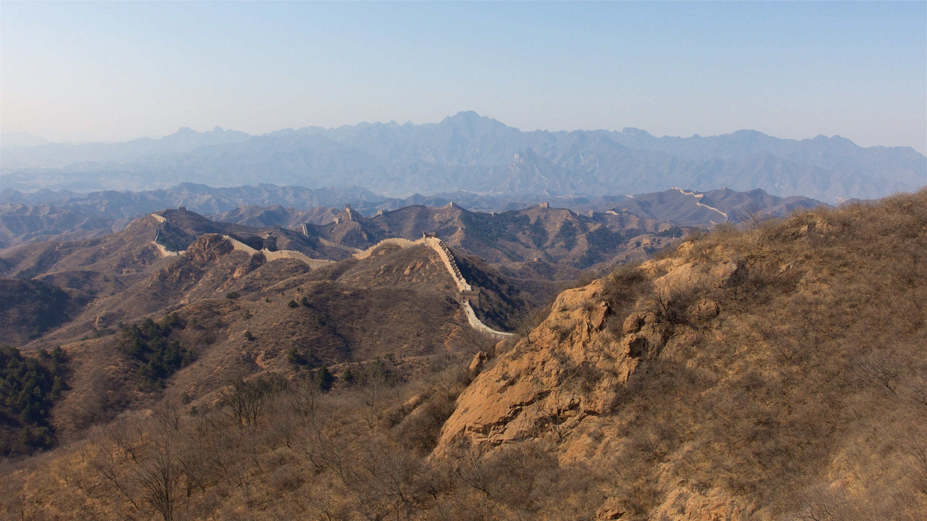 Jinshanling Great Wall which includes landscape views, tranquil scenes and a sunset
