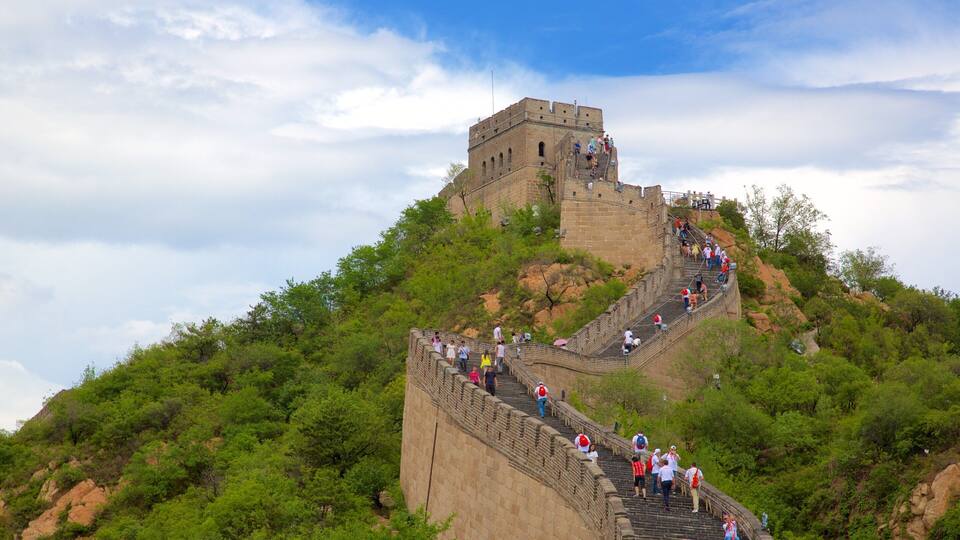 The Great Wall of China with tourists walking along its steep, stone steps.