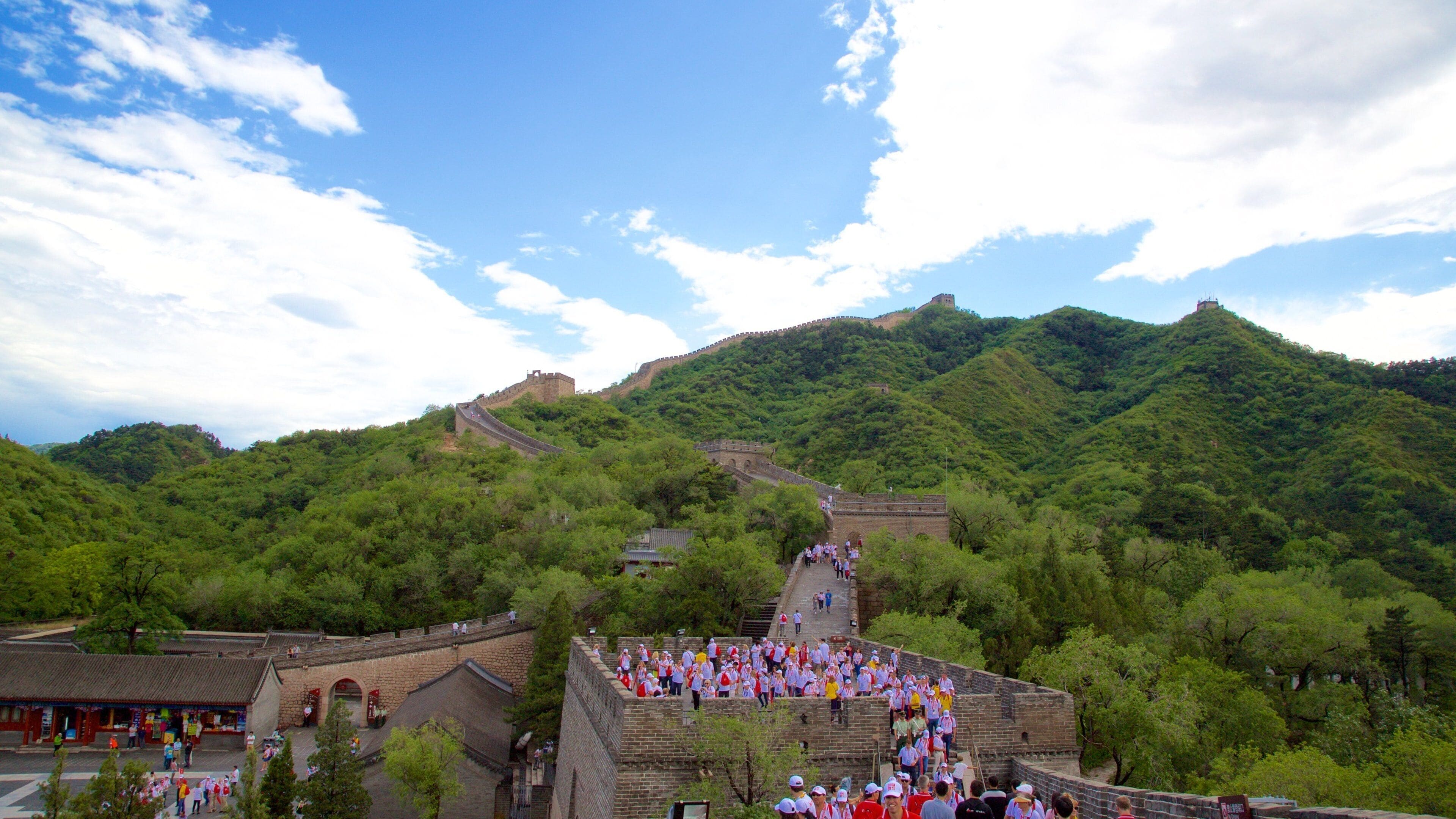 The Great Wall of China with lush green hills in the background.