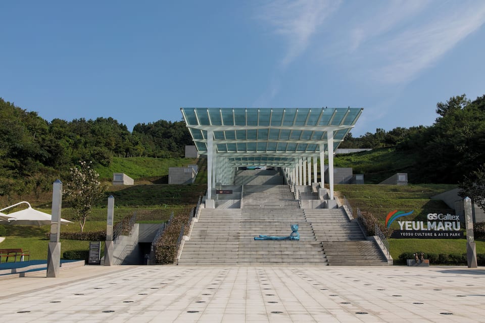 A modern pavilion with a glass roof at Yeosu Culture & Arts Park.