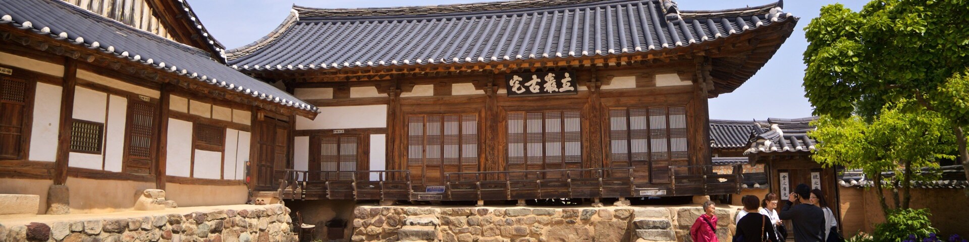 Andong Hahoe Folk Village featuring a small town or village and heritage elements as well as a small group of people