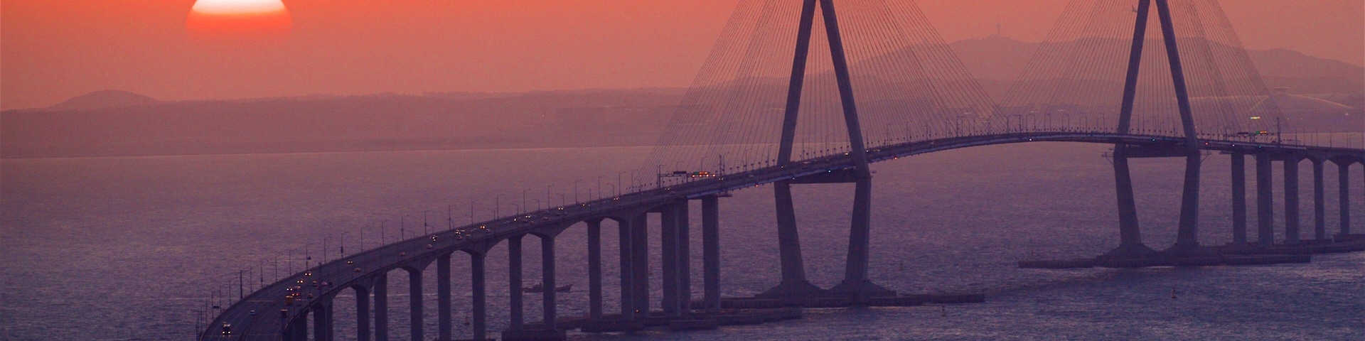 Incheon Bridge featuring a sunset, a bridge and landscape views