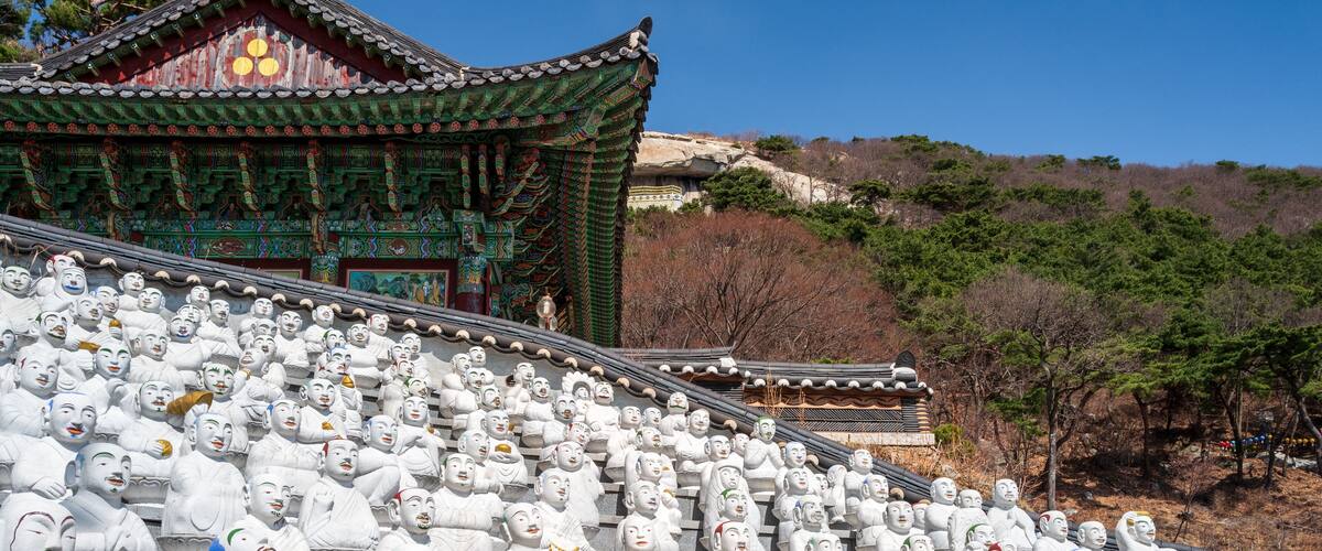 Many of the 500 Buddha’s Disciples statues by a temple hall in Bomunsa Temple on the island of Seongmodo, Ganghwa, Incheon, South Korea.