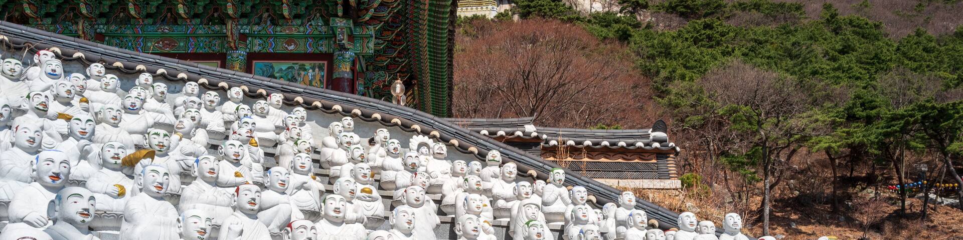 Many of the 500 Buddha’s Disciples statues by a temple hall in Bomunsa Temple on the island of Seongmodo, Ganghwa, Incheon, South Korea.