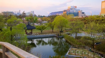 Wolmi Traditional Park featuring a sunset, a pond and a city
