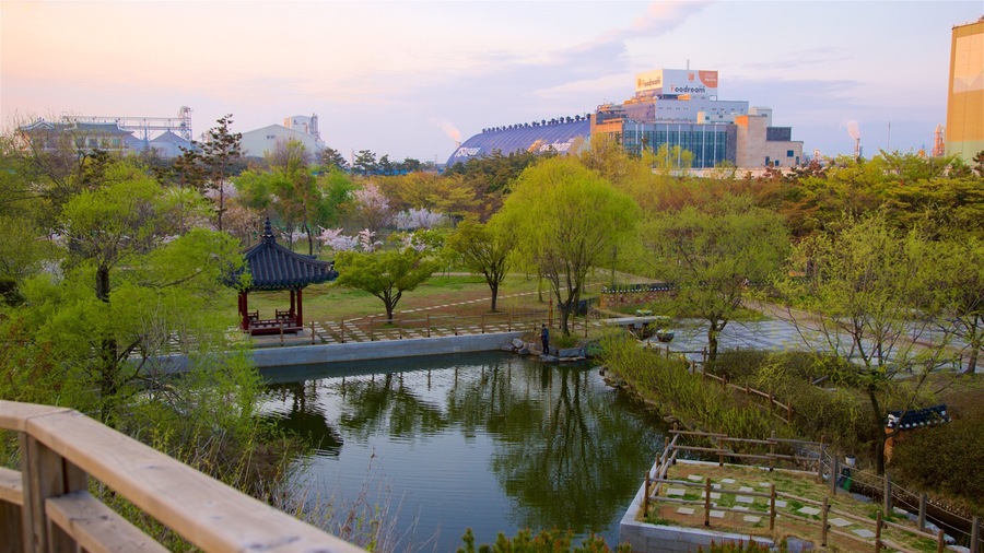 Wolmi Traditional Park featuring a sunset, a pond and a city