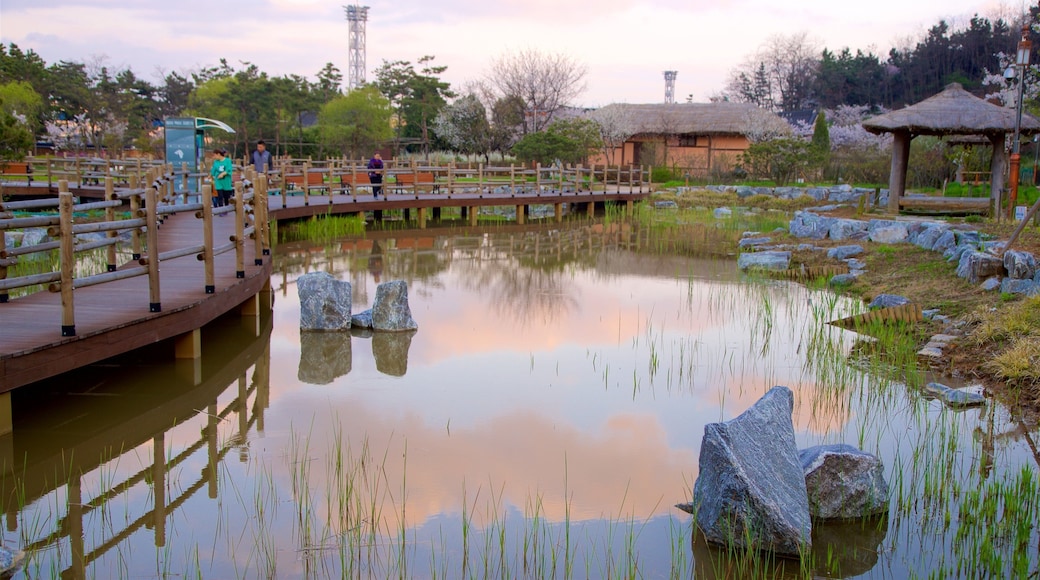 Wolmi Traditional Park which includes a sunset, a pond and a park