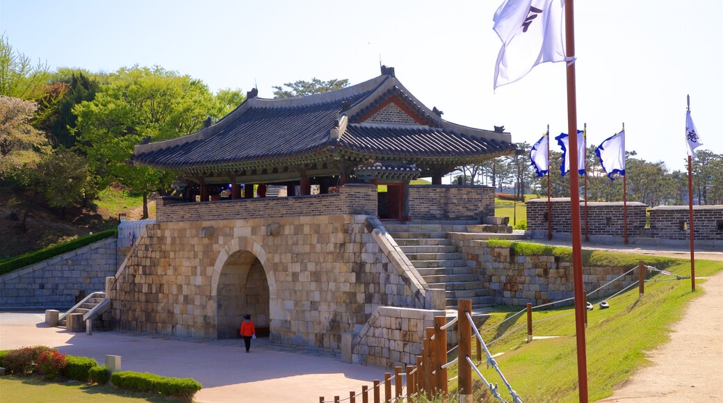 Hwaseomun Gate featuring heritage architecture and a garden