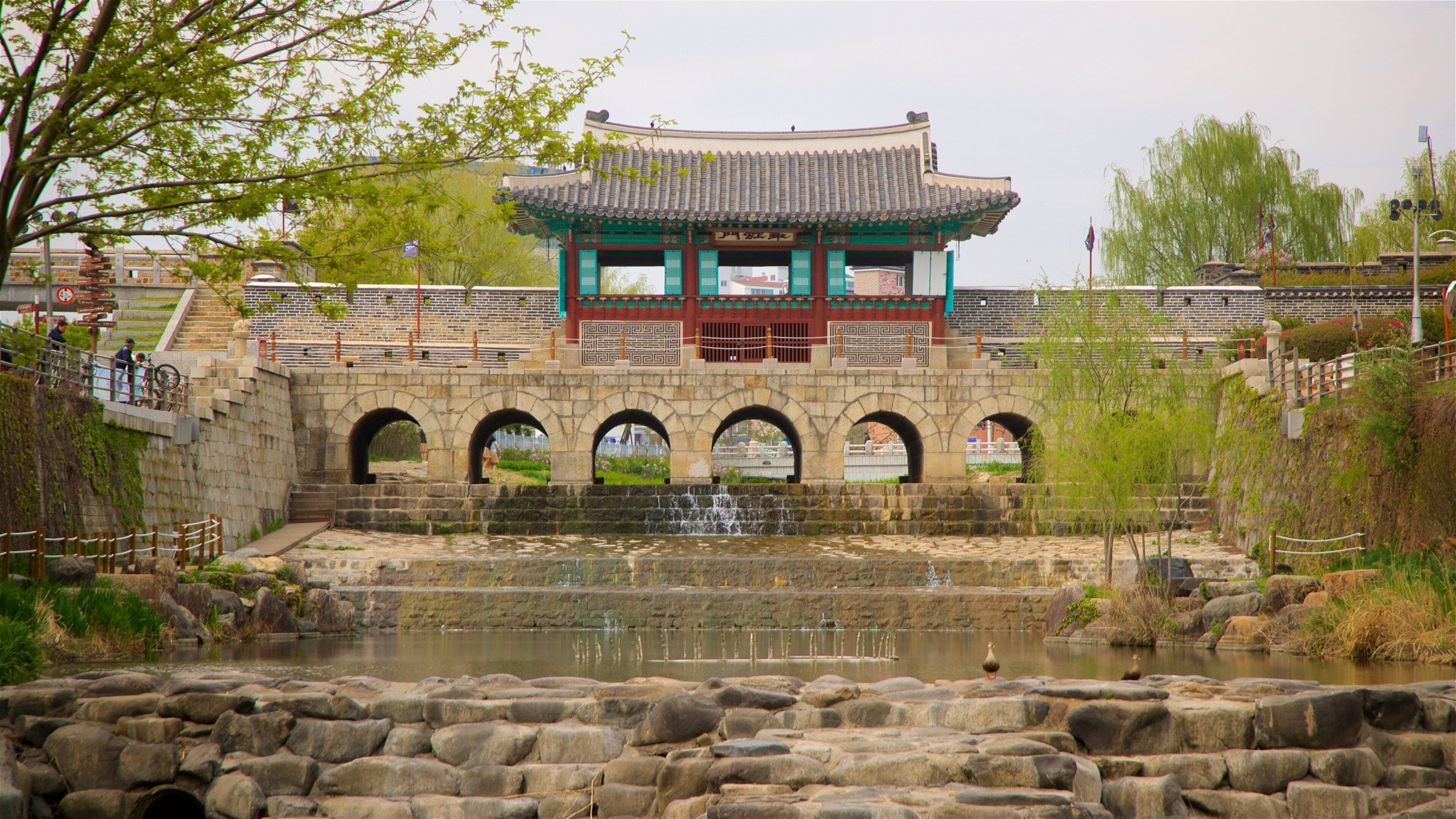 Hwahongmun Gate showing heritage architecture, a river or creek and a bridge