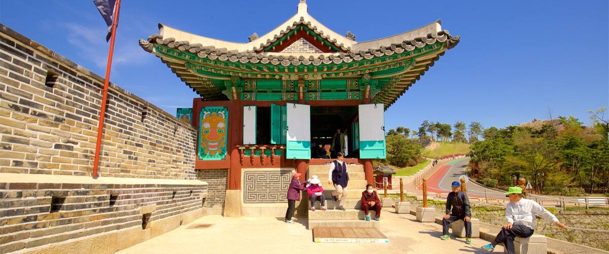 Hwahongmun Gate featuring heritage architecture as well as a small group of people