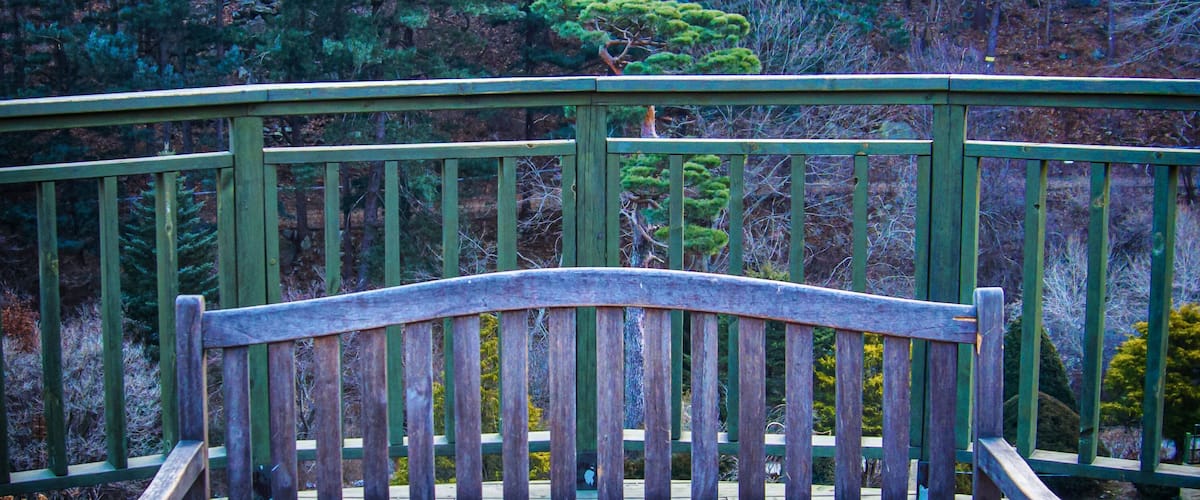 Viewing deck overlooking a stream with view of the nearby hills.