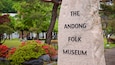 Andong Folk Museum showing wildflowers, signage and a park