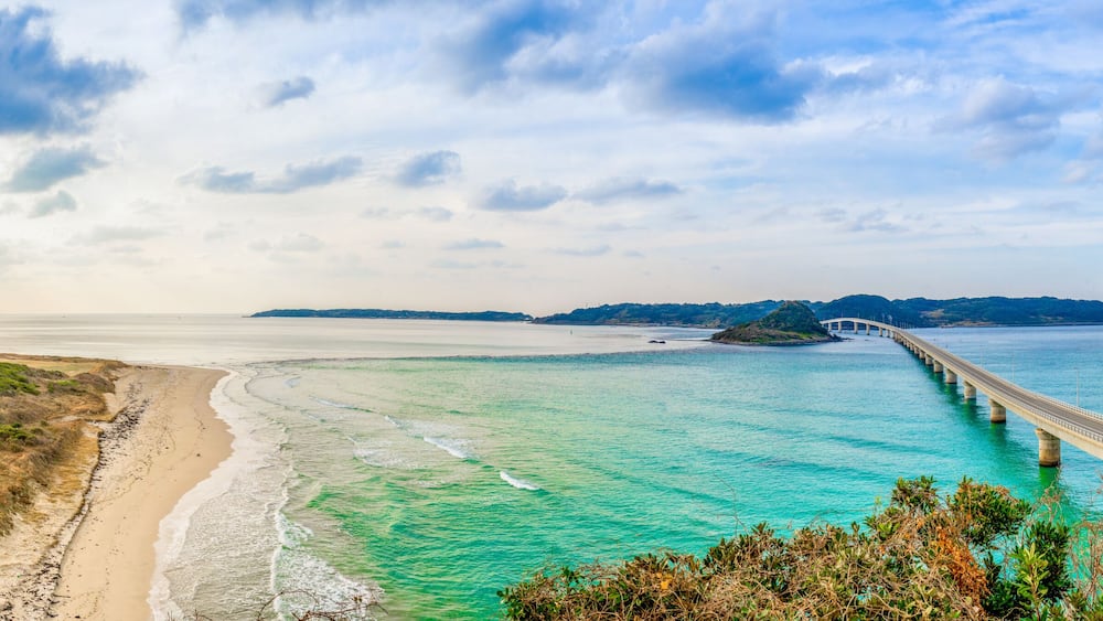 Panorama view of Tsunoshima Ohashi Bridge in Shimonoseki with sand beach in sunny day. The bridge located off the northwest coast of Yamaguchi Prefecture by the Sea of Japan.