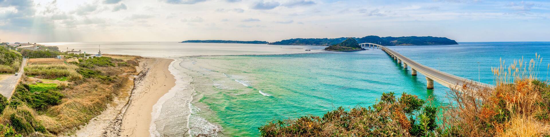 Panorama view of Tsunoshima Ohashi Bridge in Shimonoseki with sand beach in sunny day. The bridge located off the northwest coast of Yamaguchi Prefecture by the Sea of Japan.