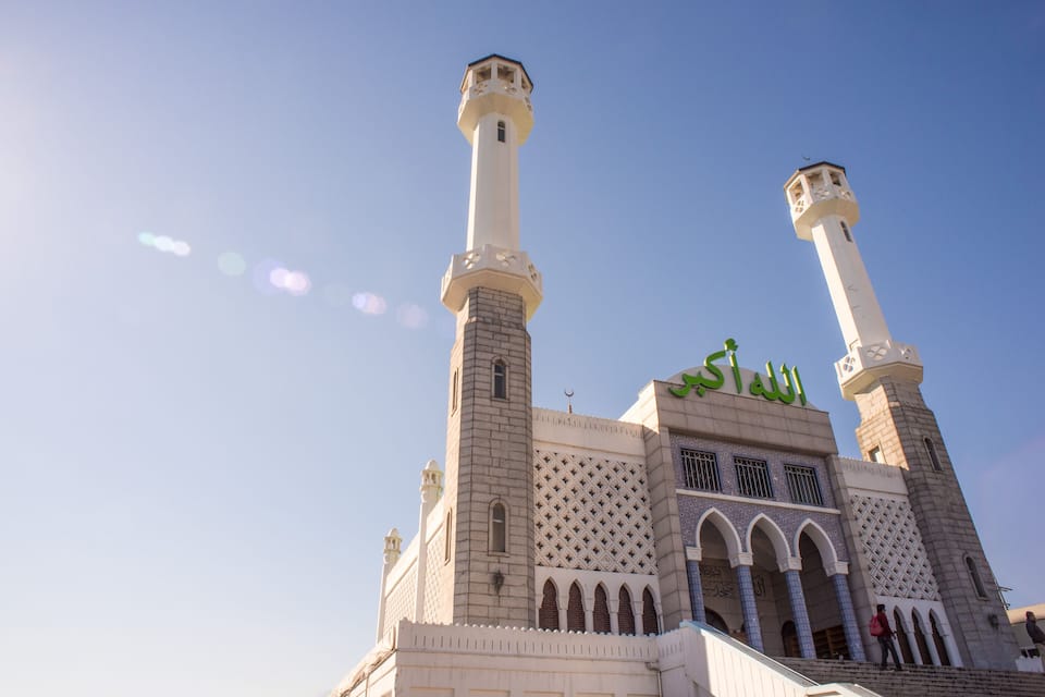 A mosque with two tall minarets and a large dome.