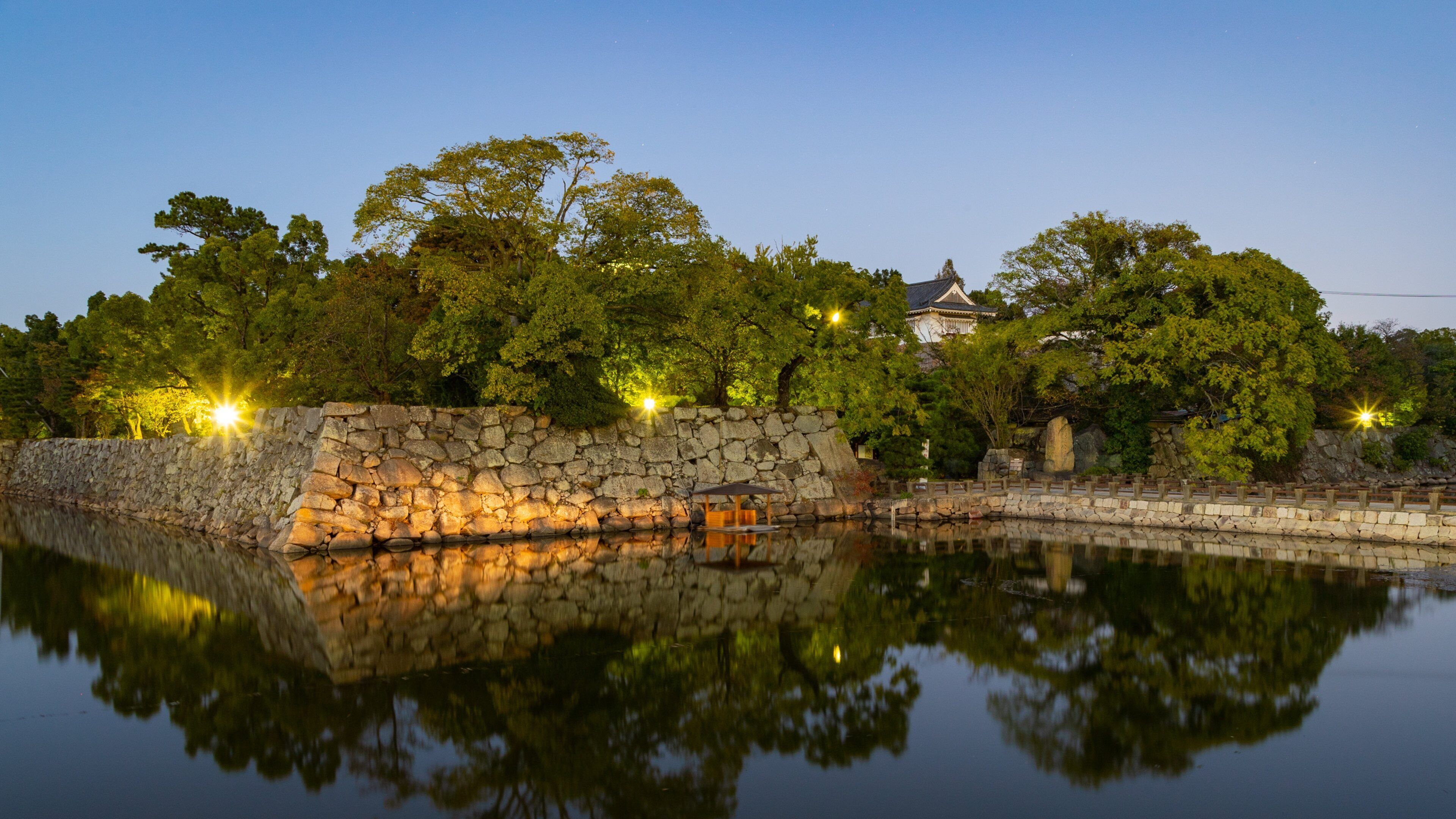 Ujo Park which includes night scenes and a lake or waterhole