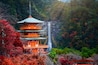 Kumano nachi taisha shrine with waterfalls along in view at season change of Autumn, the famous and popular tourist place in Kumano of Japan