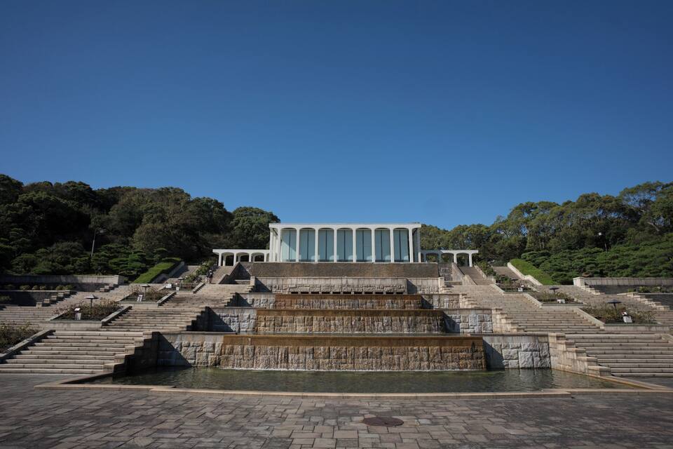 A large building with a stepped water feature in front.