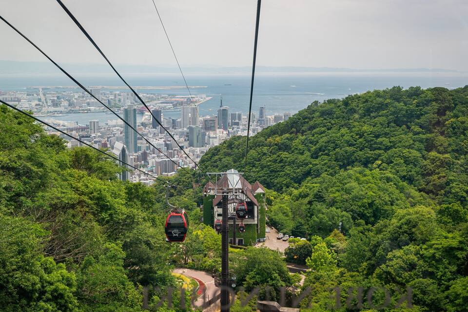A cable car system with a cityscape in the background.