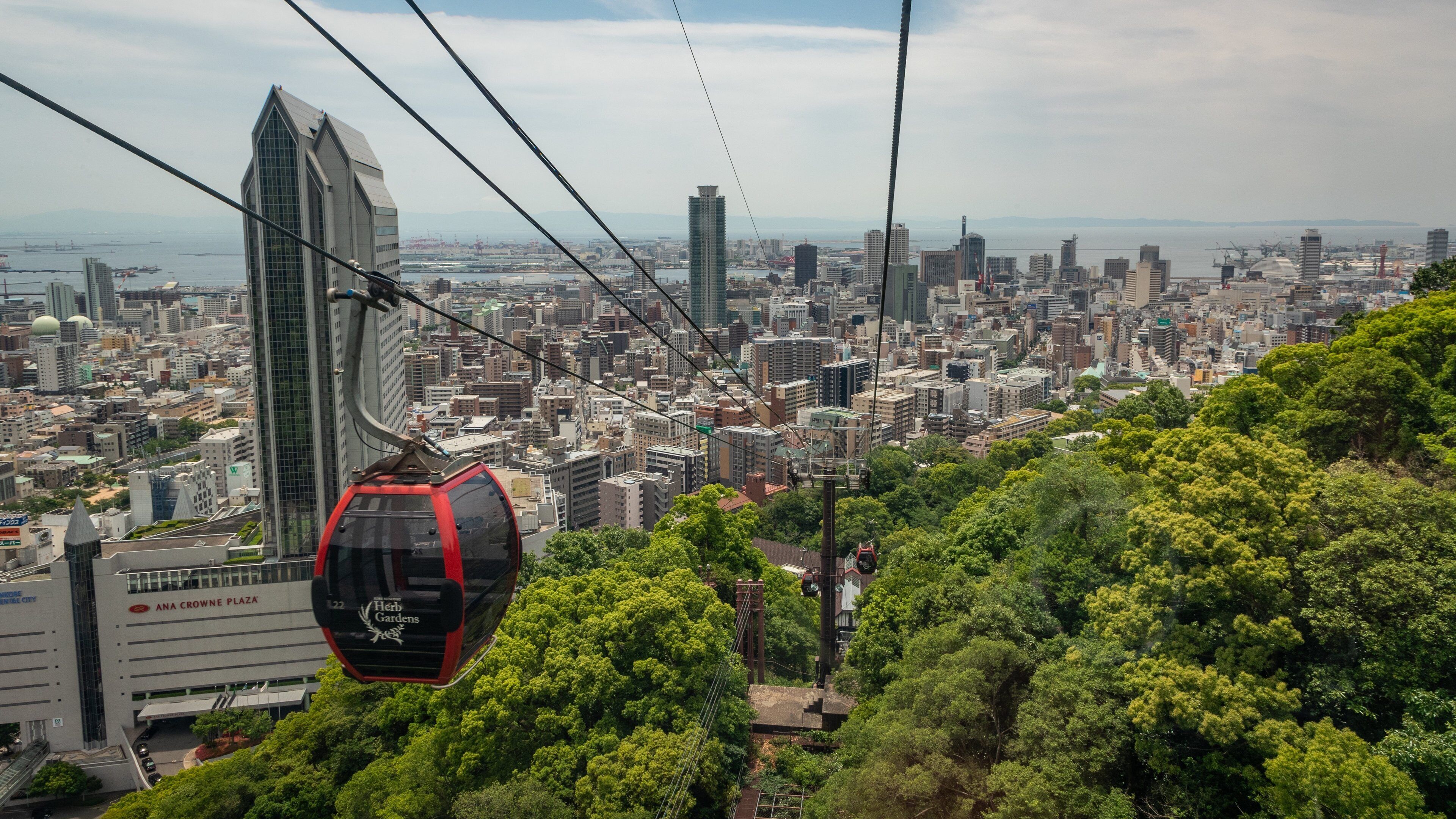 Shin-Kobe Ropeway showing a gondola, landscape views and a city