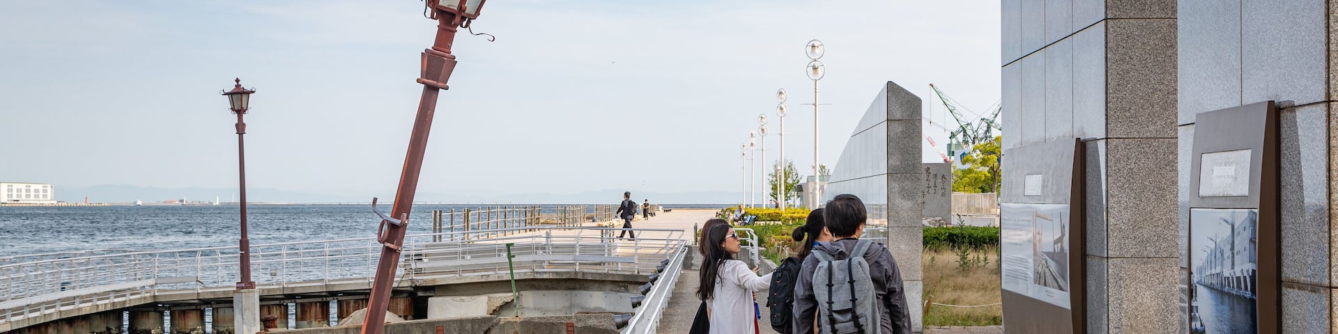 Port of Kobe Earthquake Memorial showing general coastal views as well as a small group of people